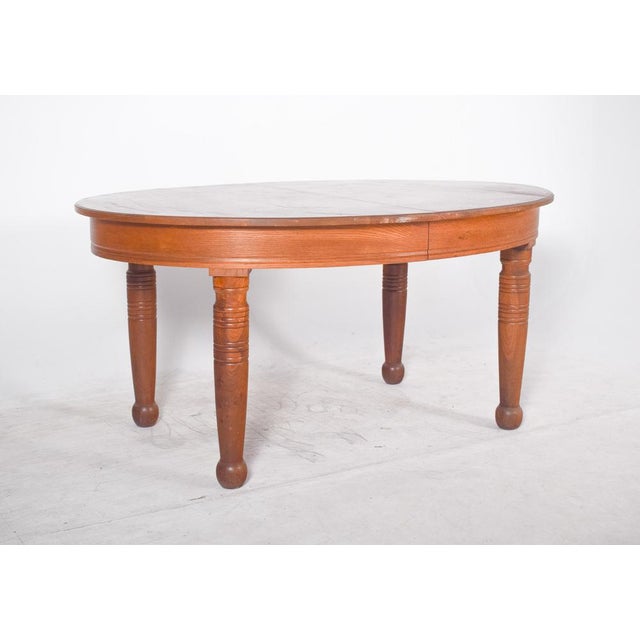 Oval oak dining table. It has a classic shape with gently rounded edges, offering a cosy, traditional touch to the space...