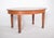 Oval oak dining table. It has a classic shape with gently rounded edges, offering a cosy, traditional touch to the space...