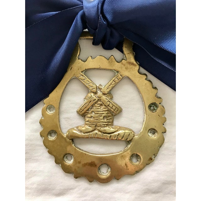 This horse brass ornament is cast as a windmill enclosed within a circular reserve pierced and with scalloped rim. With...