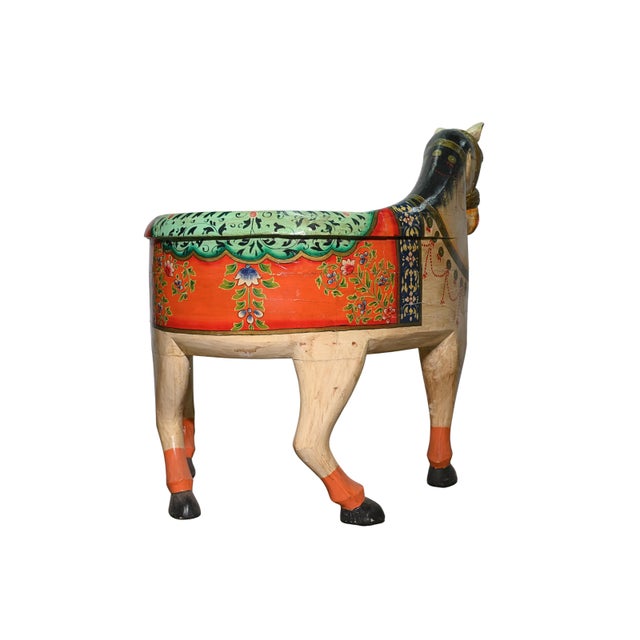 This striking vintage wooden bench is masterfully carved in the form of a horse, complete with a sculpted head and tail,...