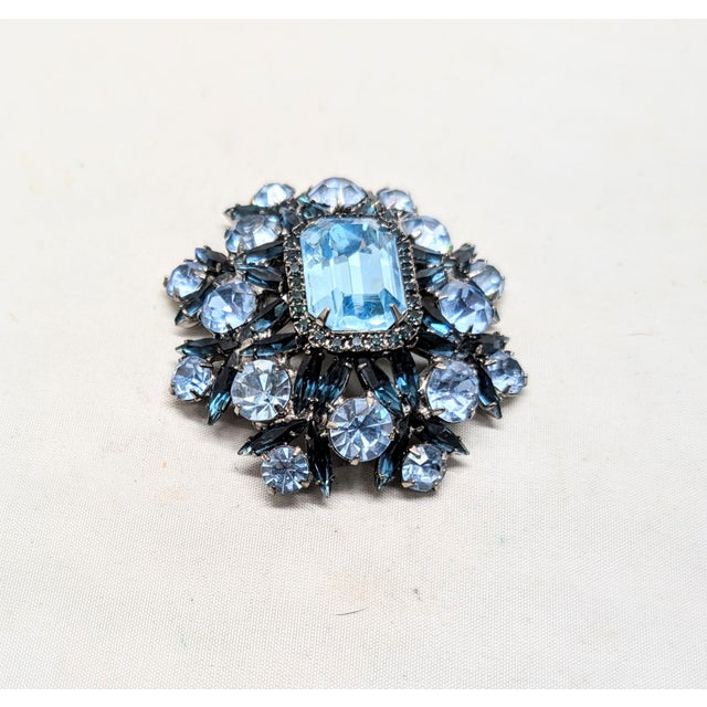 1980s or 1990s rhodium plated central emerald cut faux-aquamarine with small round aquamarine surround with round larger...