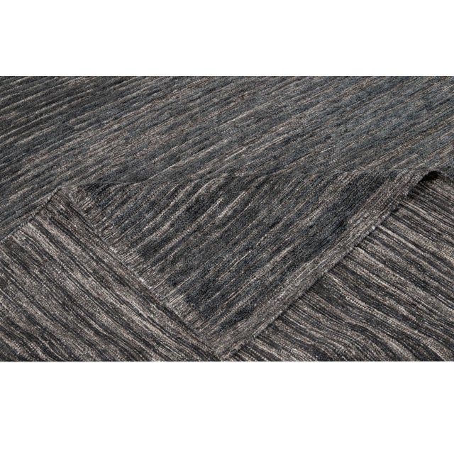 Beautiful 21st Century Modern Textured High Low Indian Rug, hand-knotted wool with a denim field and gray accents. This...