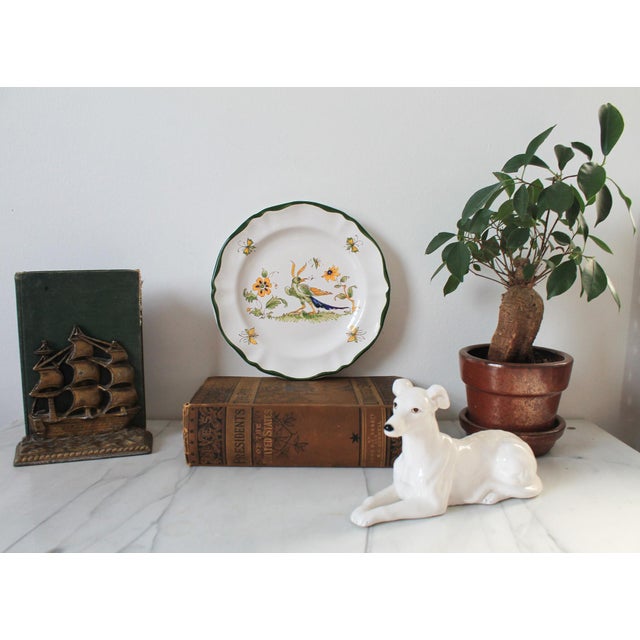 Vintage Varages hand painted floral bird and butterfly plate. No makers mark. Some small chips to bottom rim. Pictured.