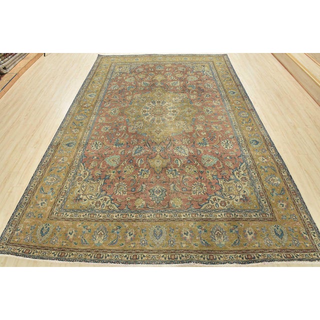 An authentic vintage traditional Tabriz rug hand-knotted with fine wool and natural dyes. This oriental rug features a...