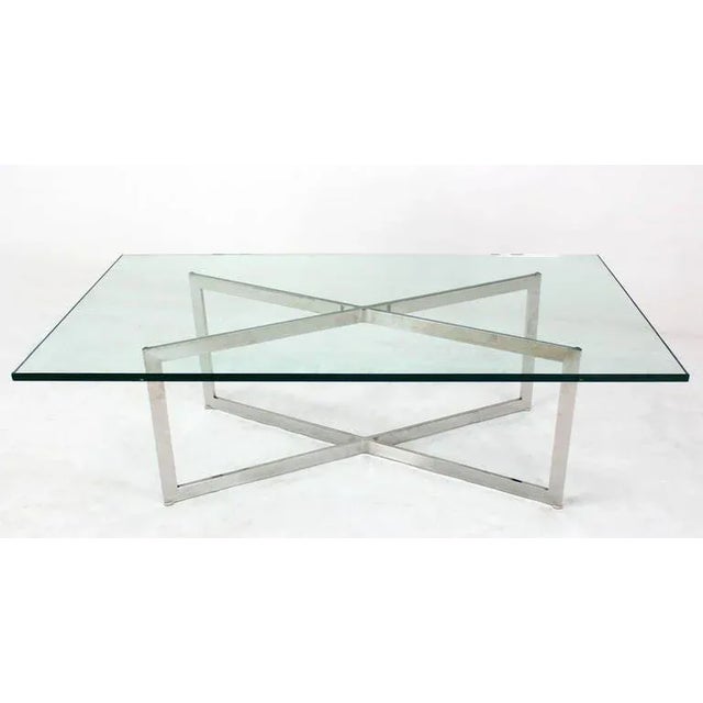 Nice mid-century modern glass top x-base rectangular coffee table. The frame is polished stainless steel.