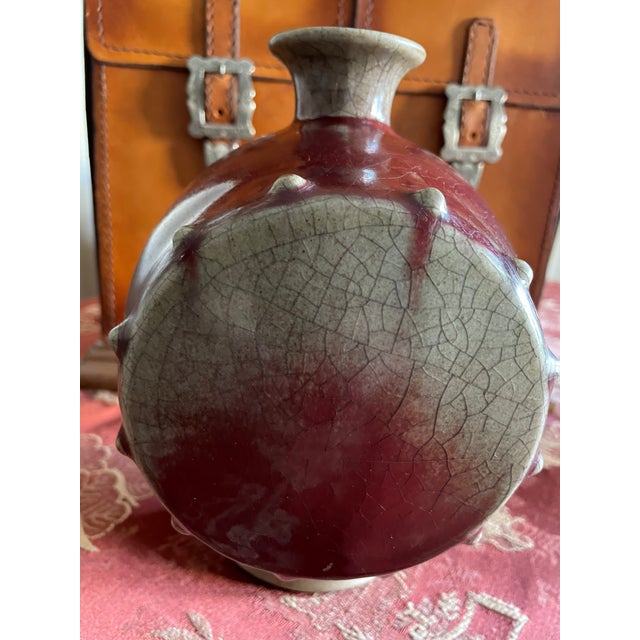 This unique mid-19th century double-drum wine bottle/vase is a fine example of Asian ceramic art. It features a rich...