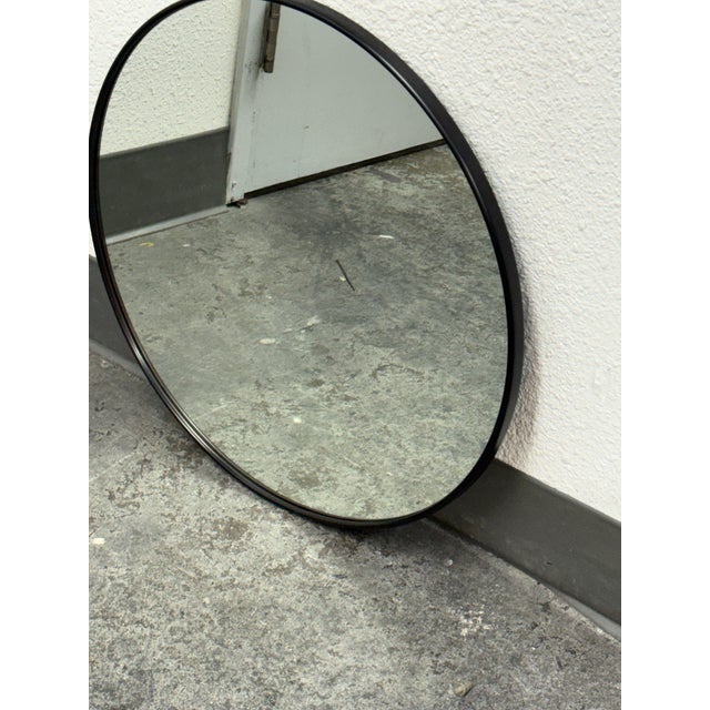 Design Plus Gallery presents a Metal Framed Mirror from Rejuvenation. The mirror showcases a clean circular profile with a...