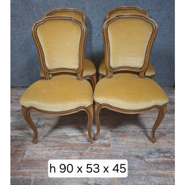 Set of four antique louis xv style chairs, in carved and molded wood, upholstered in golden yellow fabric. the chairs...