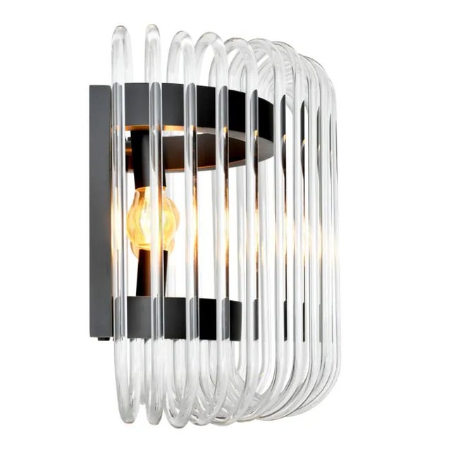 Curved glass rods surround bronze sconce, providing 1920's appeal.