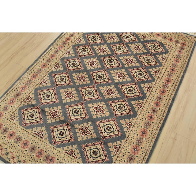 A tribal Bokhara Jaldar rug hand-knotted with an all-wool pile on a cotton foundation. This finely woven oriental rug...