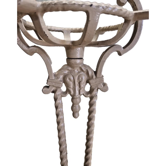 Elegant antique cast iron pedestal ashtray stand, dating from the 1920s–40s. This classic smoking-stand form features...