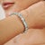 This elegant tennis bracelet is crafted in 925 sterling silver and set with 33 natural Blue Topaz gemstones totaling an...