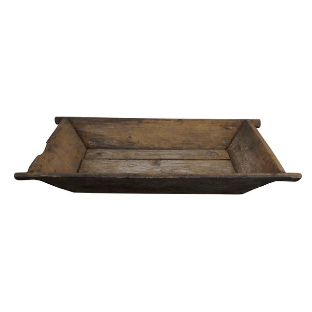 Large antique rustic wooden dough bowl / trencher. Rectangular in form with slanted sides and hand holds at each corner....