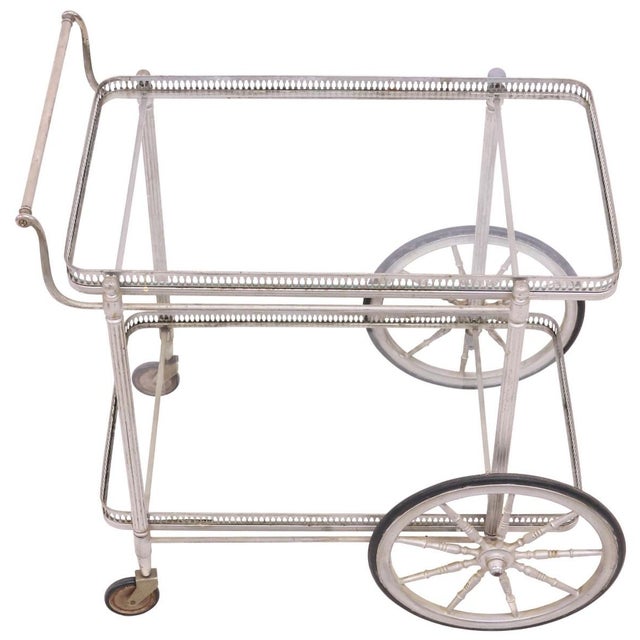 French silver-tone metal service trolley/ bar cart, mid 20th c., having two colorless glass tiers, with pierced gallery,...