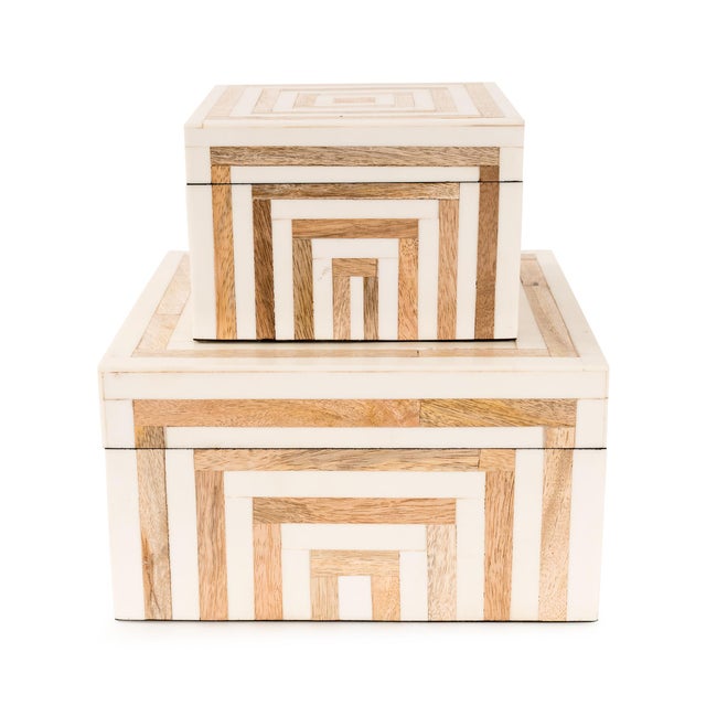 Crafted with precision, these decorative boxes feature a striking geometric inlay of natural wood and bone tones, creating...