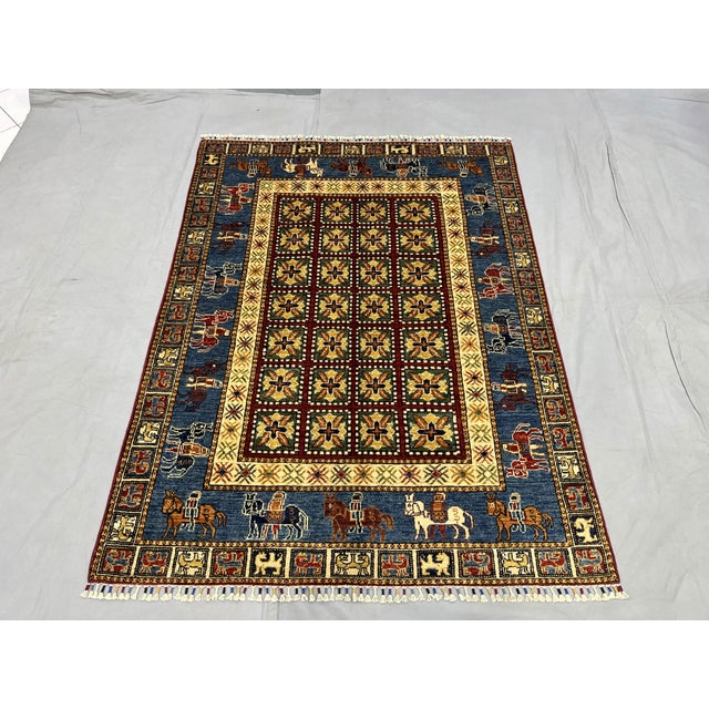 This pictorial Sultani rug pairs a grid of repeating geometric floral motifs with an unusual border of saddled horses. A...