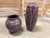 This hand-thrown Door Pottery vase features a rich matte mauve glaze with sculpted organic leaf forms and delicate...