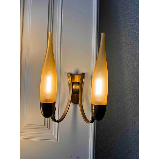 Discover the epitome of mid-century modern elegance with this stunning set of sconce lamps by Angelo Lelii for Arredoluce,...