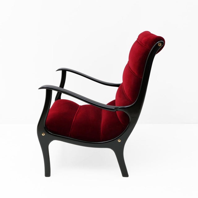 Mitzi armchair in Mid-Century Modern style with a black ebonized wood frame and original burgundy velvet upholstery....