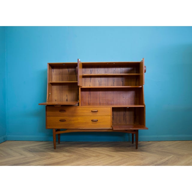 A large highboard by G Plan for the Brasilia range - Circa 1960s Featuring two pull down drinks cabinets, a cupboard and...