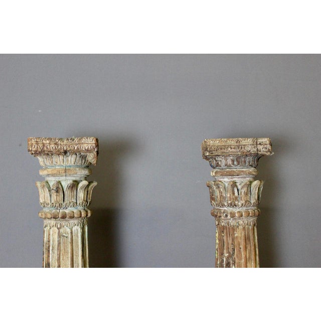 Pair of carved wooden columns with traces of polychromy, of Indian origin, constructed in two parts, small bases measuring...