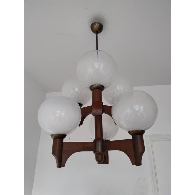 Wonderful mid century modern wooden glass chandelier made by Sijaj Hrastnik in Slovenia,70s. Its modern and timeless...