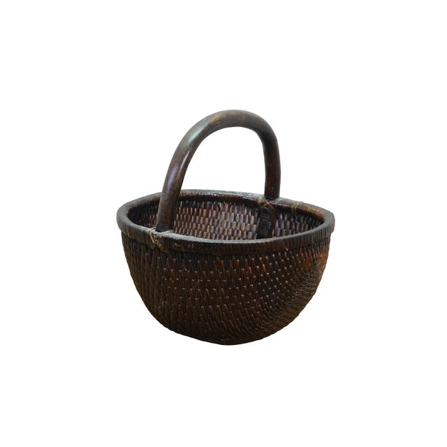 Antique Chinese rice basket / magazine rack / log holder featuring woven reed and willow with bentwood handle. Dimensions:...