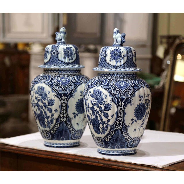 This elegant pair of vintage Delft ginger jars combines classic Dutch blue-and-white decoration with a richly detailed,...