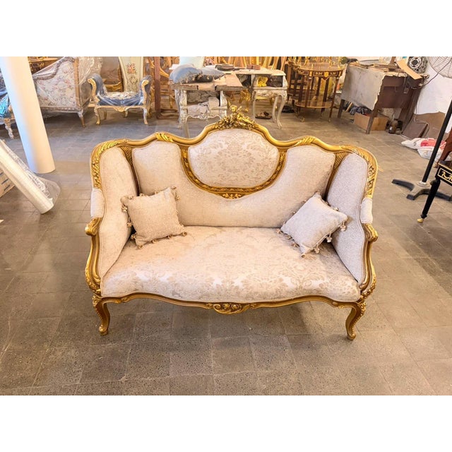 Bring the elegance of a French salon into your home with this magnificent Louis XV-style canapé loveseat, beautifully...