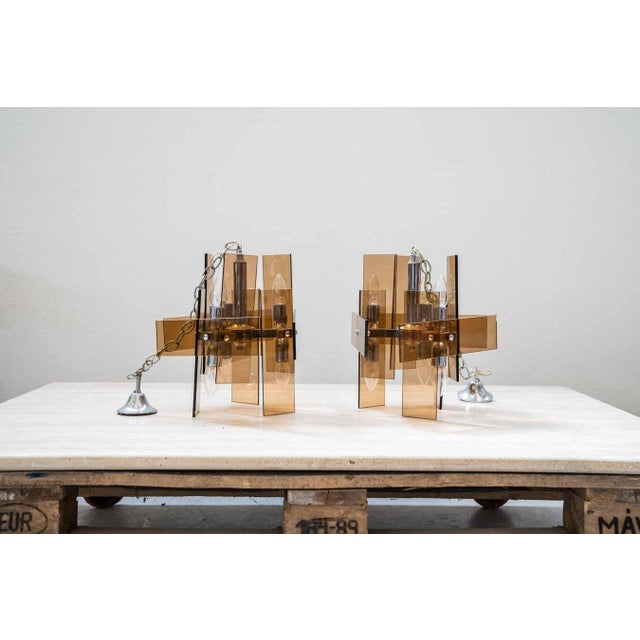 Lamps in orange glass and chromed iron structure, with six bulbs each Maximum height (from the wall to the end of the...