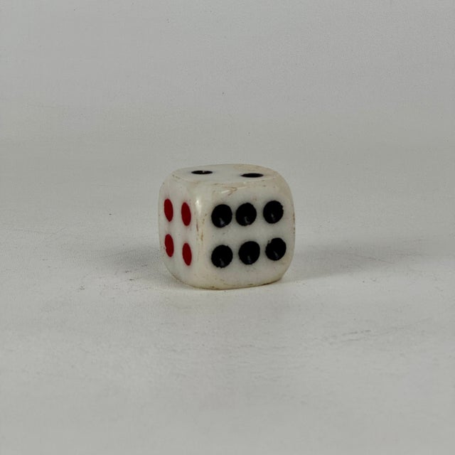 A large white marble with red and black count game dice for decorative decor and home accent. Circa: Late 20th Century...