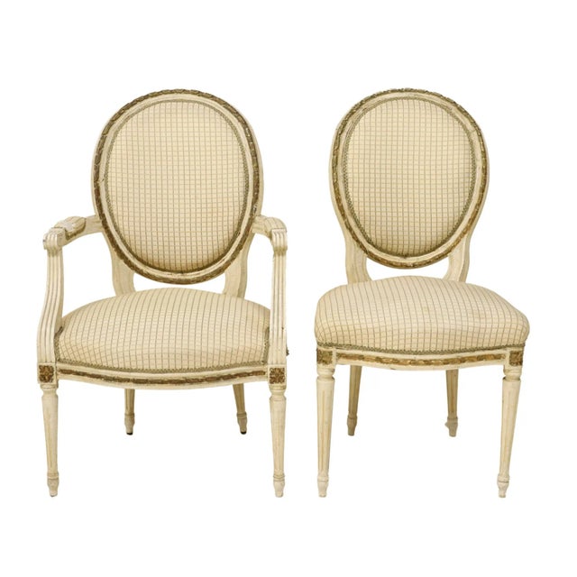 Six French Louis XVI style dining chairs, with oval medallion backs, ribbon twist molding. and patterned upholstery with...