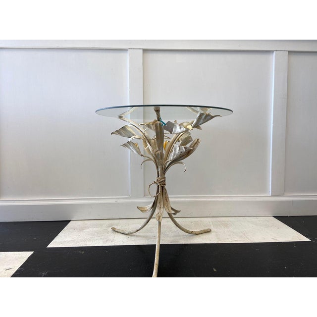 This striking mid-century Italian tole table is a sculptural celebration of nature, featuring a bouquet of hand-painted...
