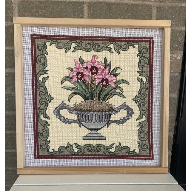 Gorgeous cross stitch on working frame. Cross stitch is of pink flowers in an urn. Can be hung as is, turned into a...