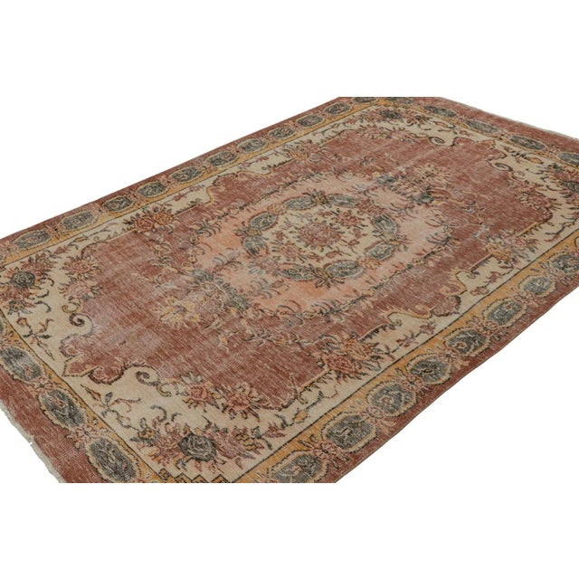 Hand-knotted in wool, circa 1960 - 1970, this 6x9 vintage French Savonnerie-inspired Müren rug is a modern interpretation...