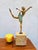 Elegant bronze ballerina with a multicolored patina, poised on pointe, mounted on a marble base. This sculpture is signed...