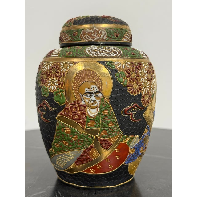Design Plus Gallery presents a Japanese Satsuma Style Moriage Porcelain Lidded Ginger Jar. The vessel has a rounded form...