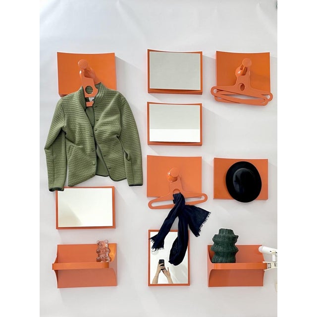 1960s orange plastic wall cabinet consisting of 4 mirrors (have been replaced with new ones), 3 coat racks, 4 hangers, 2...