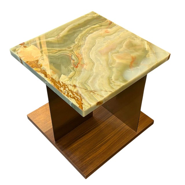Elegant end table featuring a richly veined green onyx top paired with a warm wood base, creating a striking contrast...