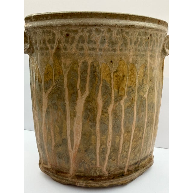 Beautiful handmade studio pottery vessel featuring an organically shaped oval form with sculptural side lug details and an...