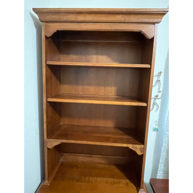 Diverse functionality in the form of two-drawer filing cabinet bottom and 4-shelf bookcase top combined with the cinnamon...