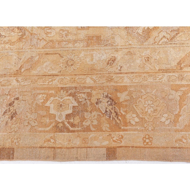 An early 20th century North Indian Amritsar antique rug, the abrashed pale peach field with an unusual overall stepped...