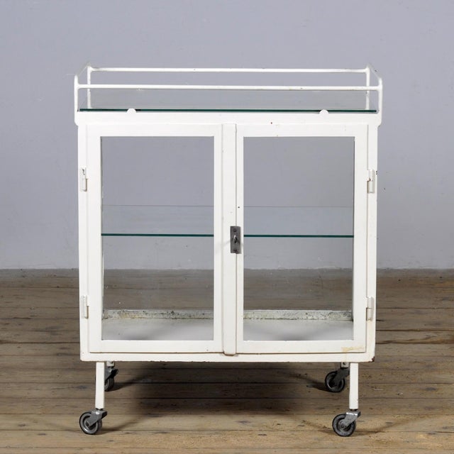 Crafted from sturdy iron and glass, the trolley was originally produced in Hungary in the 1940s. Its industrial design and...