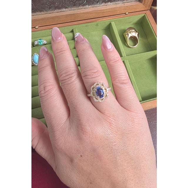 We offer free 2-day shipping! This is an 18K gold ring featuring an elongated natural blue sapphire and pave set diamonds....