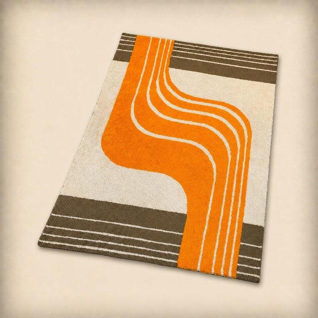 Rug with striking geometric patterns. Desso edition, Netherlands, circa 1970. Machine-woven rug, orange, beige and brown...