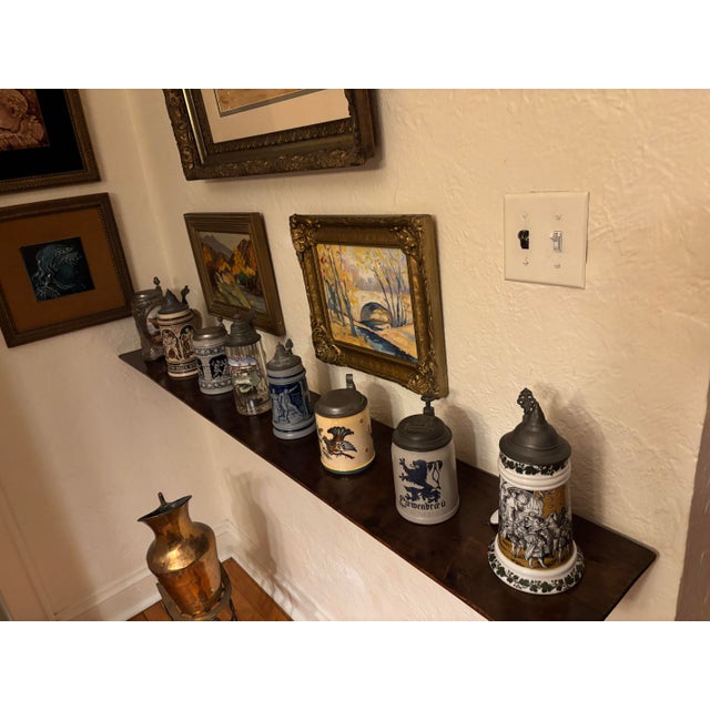 This exceptional set of eight beer steins represents a rich tapestry of European craftsmanship, spanning nearly a century...