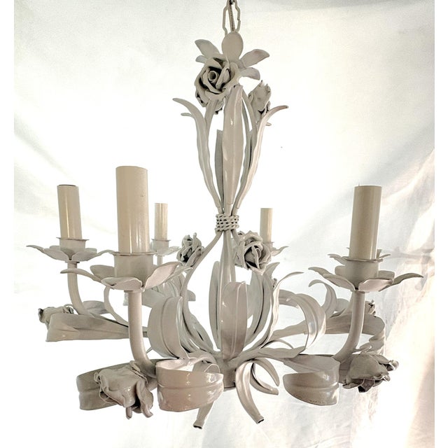 Precious metal tole chandelier from the late 20th century. This piece has six lights and has been recently painted in a...