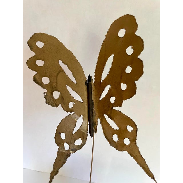 This striking vintage butterfly sculpture features a delicately balanced brutalist design crafted from torch-cut metal and...