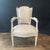 An elegant pair of antique French Louis XVI fauteuils, beautifully crafted with gracefully shaped shield backs, fluted...