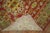A colorful fine quality early 20th century antique Khotan rug in vivid red, green and yellow accents Measures: 5'3" x 8'4"...